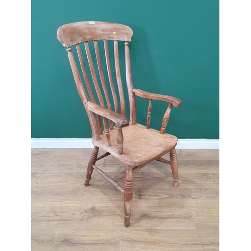 688 - A Windsor style lathe back Elbow Chair on turned supports and H stretcher. (R9).