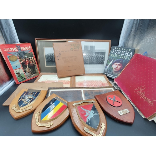 73 - A box of Military Related Items including figures ,books, mug, pictures, photographs, shields, etc (... 