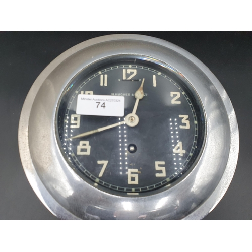 74 - A ships Clock with black dial inscribed H. Hughes and Son LTD 9in Dia. (R1)