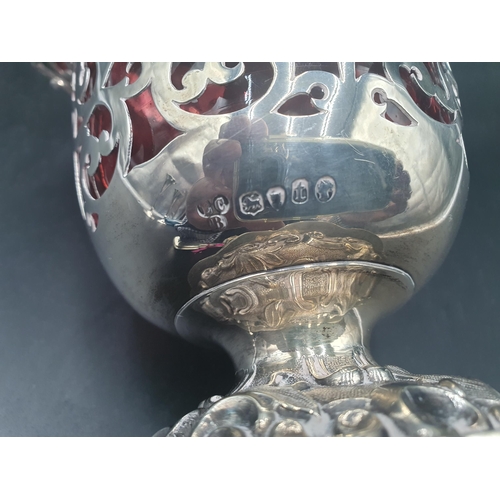 84 - A Victorian silver Basket with scroll piercing, swing handle and embossed pedestal base, fitted cran... 