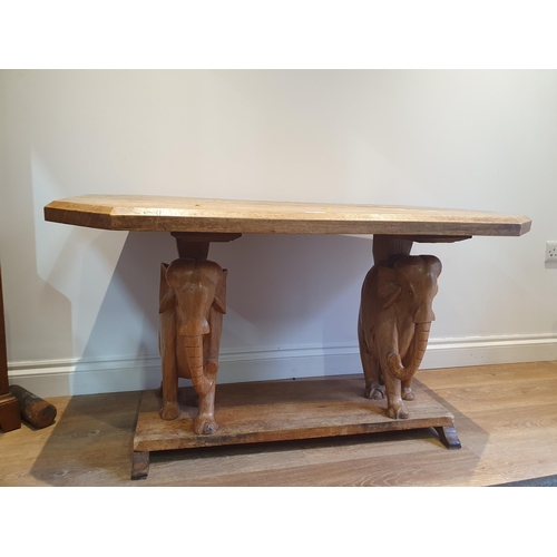 877 - A hardwood Coffee Table on carved Elephant supports and plinth base, 2ft 1