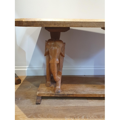 877 - A hardwood Coffee Table on carved Elephant supports and plinth base, 2ft 1