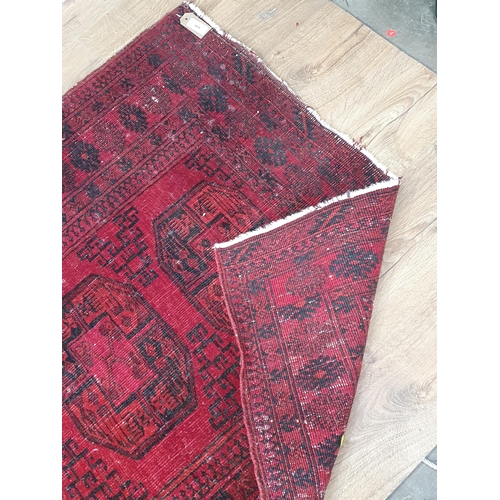 889 - A Turkish Rug with multiple borders, and decorated medallions on a red ground, A/F 6ft 1in x 3ft 5in... 