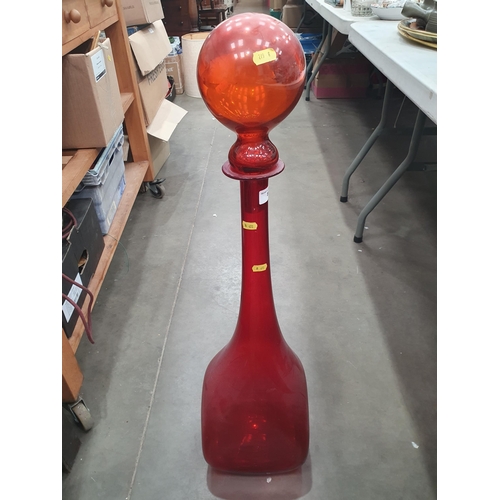 891 - A large coloured glass Bottle and Stopper, 2ft 10