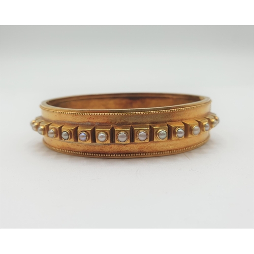 175 - A Victorian hinged gold Bangle the front set row of seed pearls, approx 14.80gms, unmarked, untested