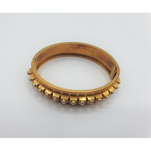 175 - A Victorian hinged gold Bangle the front set row of seed pearls, approx 14.80gms, unmarked, untested