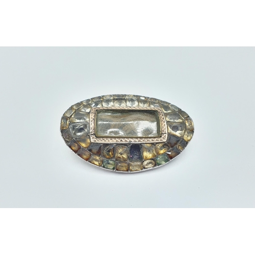 185 - A Georgian oval Mourning Brooch with lock of hair to centre within foil backed paste, approx 48mm wi... 