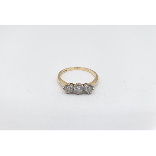 188 - A Diamond three stone Ring claw-set graduated brilliant-cut stones, stamped 18ct PLAT, ring size M 1... 