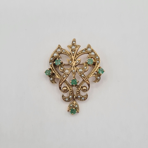 204 - An Emerald and Seed Pearl Pendant/Brooch the openwork plaque set six round emeralds and numerous see... 