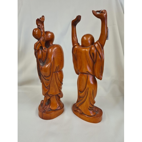 227 - Two modern Oriental wooden Figures