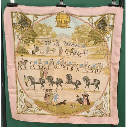 242 - A vintage Hermes silk Scarf; 'Presentation De Chevaux 1642' dressage horses in a landscape within a ... 