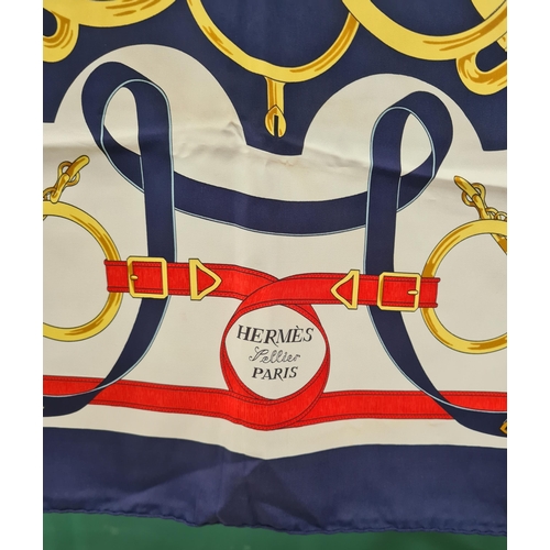 244 - A vintage Hermes silk Scarf; 'Eperon D'Or' stylised bridles, bits and stirrups in gold, red and navy... 