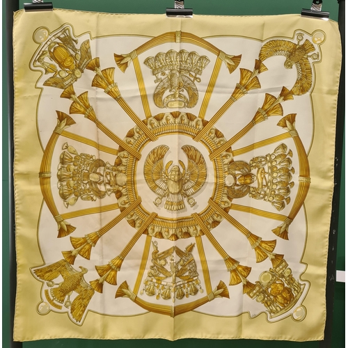 245 - A vintage Hermes silk Scarf; Egyptian influence design with scarabs, eagles etc in pale gold and gre... 