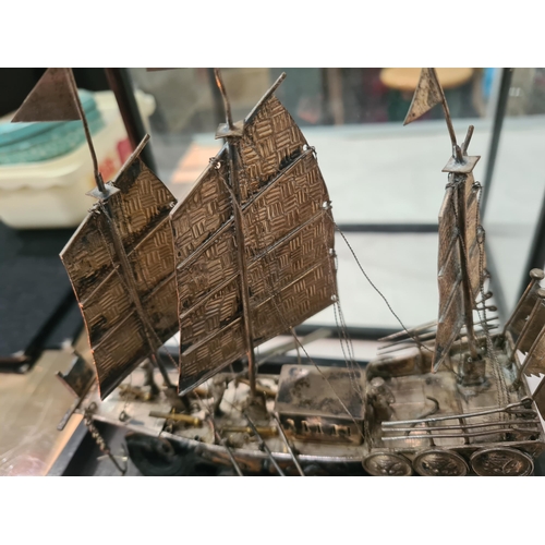 143 - A Chinese silver three masted Sailing Boat with figures and oars, and two smaller vessels, all under... 