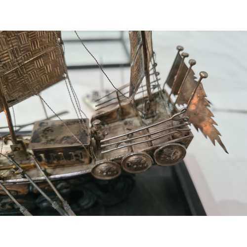 143 - A Chinese silver three masted Sailing Boat with figures and oars, and two smaller vessels, all under... 