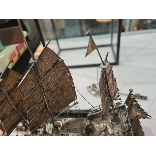 143 - A Chinese silver three masted Sailing Boat with figures and oars, and two smaller vessels, all under... 