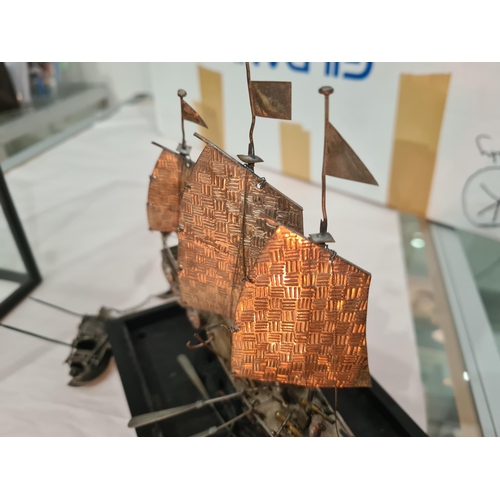 143 - A Chinese silver three masted Sailing Boat with figures and oars, and two smaller vessels, all under... 