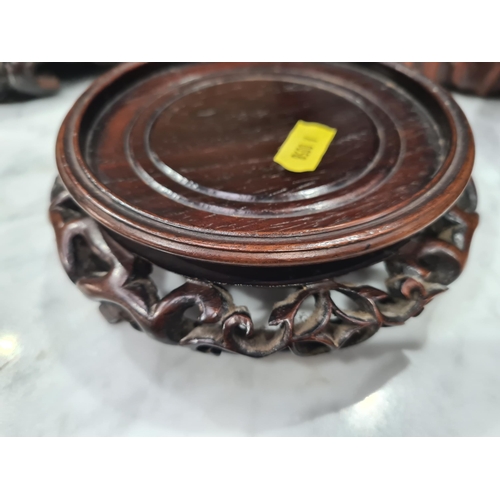 550 - A collection of twelve assorted hardwood Chinese Pot Stands some with pierced decorations and shaped... 