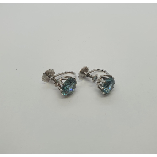 176 - A pair of blue Zircon Earrings each claw-set round stone in 9ct white gold on screw fittings