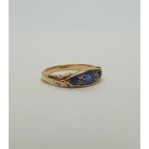 179 - A Sapphire and Diamond Ring pavé-set three graduated round sapphires interspersed with pairs of old-... 