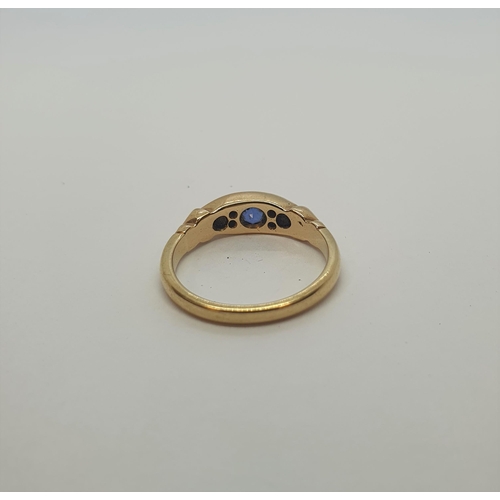 179 - A Sapphire and Diamond Ring pavé-set three graduated round sapphires interspersed with pairs of old-... 