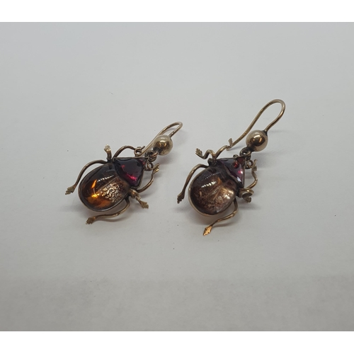 200 - A pair of Beetle Drop Earrings each set foil backed garnet and citrine on wire fittings