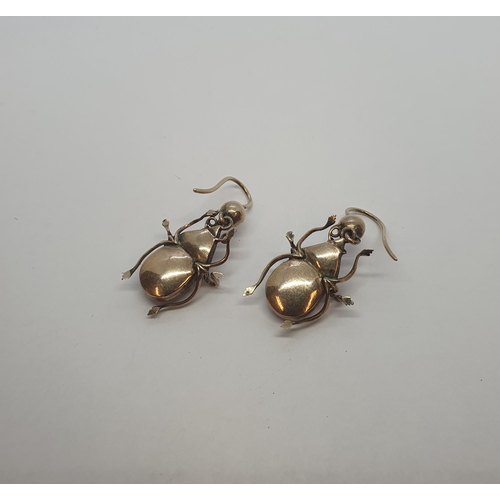 200 - A pair of Beetle Drop Earrings each set foil backed garnet and citrine on wire fittings