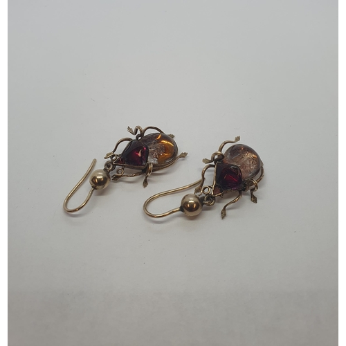 200 - A pair of Beetle Drop Earrings each set foil backed garnet and citrine on wire fittings