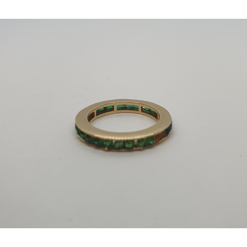 234 - An Emerald Eternity Ring channel-set cushion-cut stones, several stones deficient, unmarked, unteste... 