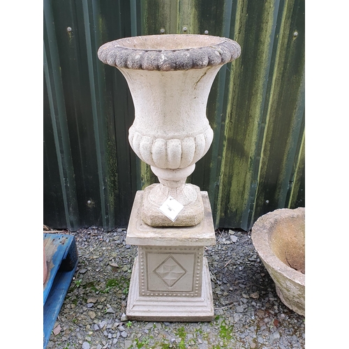 86 - A composite Garden Urn on associated decorative plinth base, 3ft 8