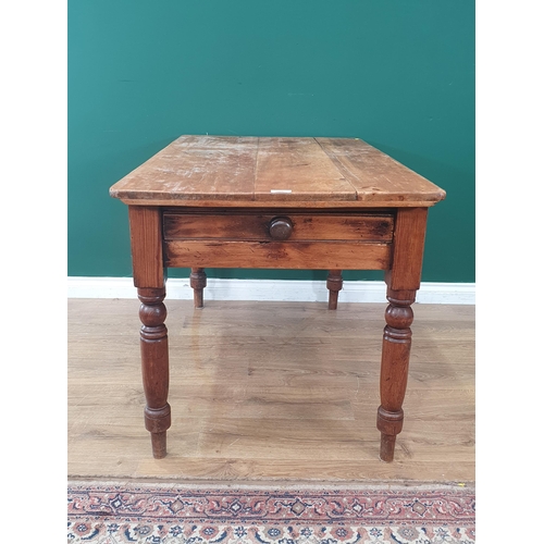 10 - A pine Kitchen Table with single fitted drawer raised on turned supports, 2ft 6in High x 4ft Long x ... 