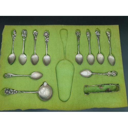 107 - A Set of ten Continental silver Coffee Spoons with flower finials, and a matching Ladle and Sugar Cl... 