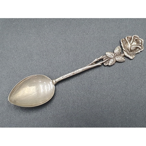 107 - A Set of ten Continental silver Coffee Spoons with flower finials, and a matching Ladle and Sugar Cl... 