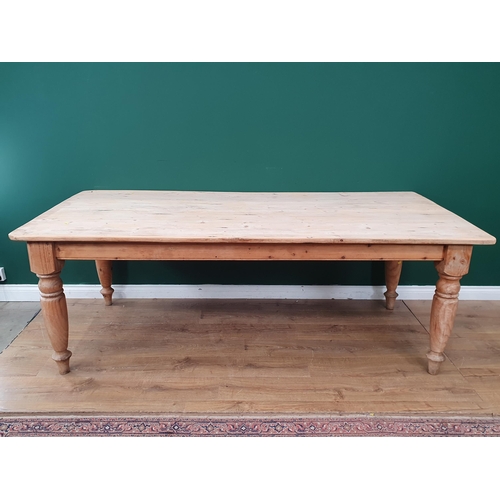 14 - A large Pine Kitchen Table on turned tapered supports, 30in High x 7ft Long x 3ft 6in Wide. (R3).