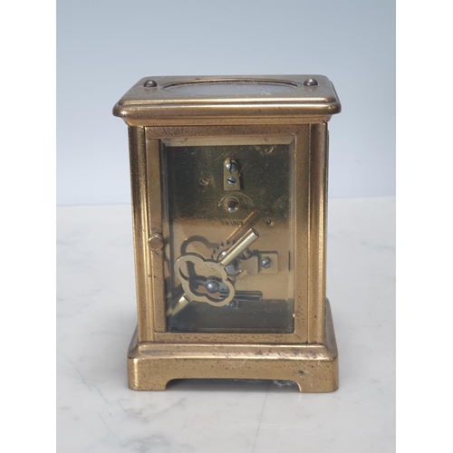 246 - A brass cased Carriage Clock with circular enamel dial, 4 1/4in H, front glass loose (Cab)