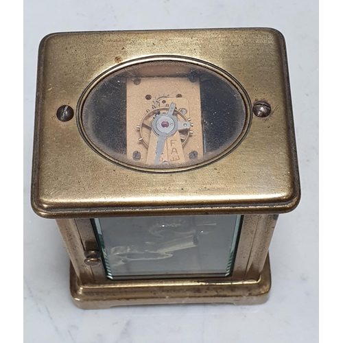 246 - A brass cased Carriage Clock with circular enamel dial, 4 1/4in H, front glass loose (Cab)