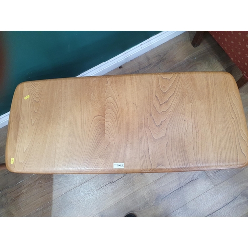 296 - An Ercol pale elm Coffee Table with rounded rectangular top and lower magazine shelf, 3ft 6in W x a ... 