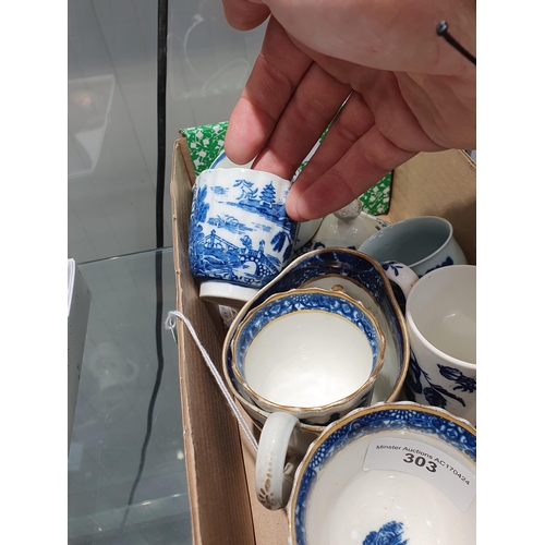 303 - Five assorted blue and white Coffee Cups, a Tea Bowl with two figures in white cartouche, an oval Ju... 