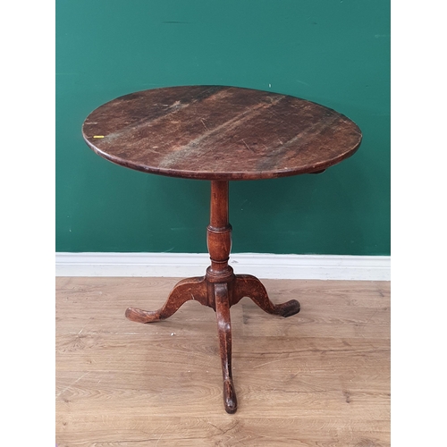 34 - An oak tilt top Tripod Table on turned column and splayed supports, A/F, 30