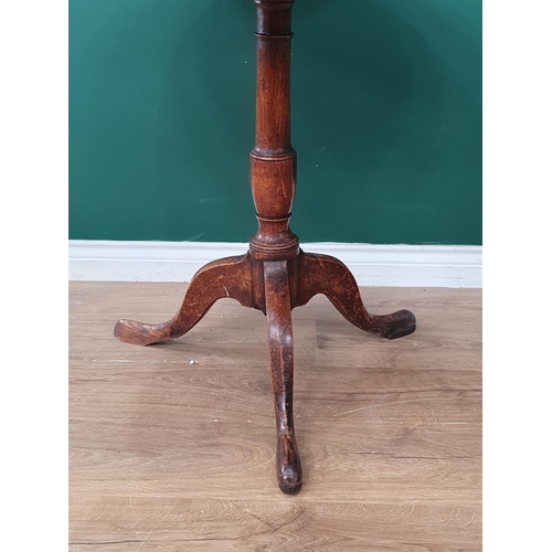 34 - An oak tilt top Tripod Table on turned column and splayed supports, A/F, 30