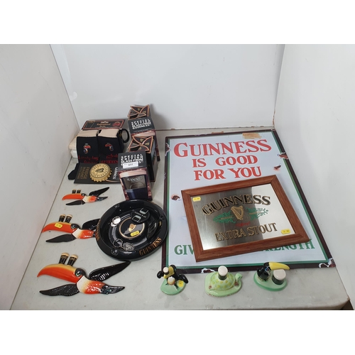 A quantity of Guinness Memorabilia including a reproduction enamel Sign ...