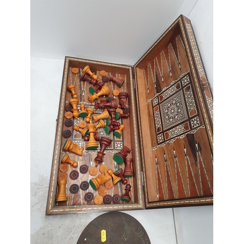 390 - An Eastern inlaid Chess Board/Box with wooden chess pieces and a metal Sun Dial