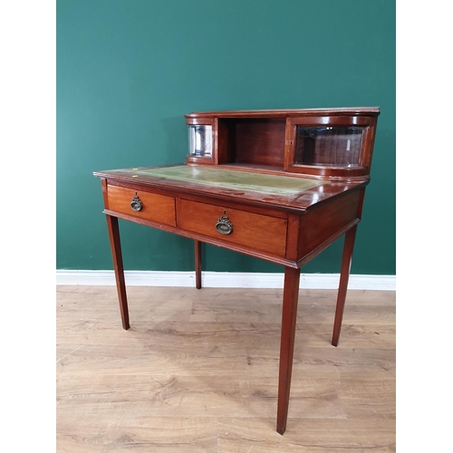 406 - A mahogany Writing Table the top with open pigeon hole, flanked by a pair of bevelled glazed doors, ... 