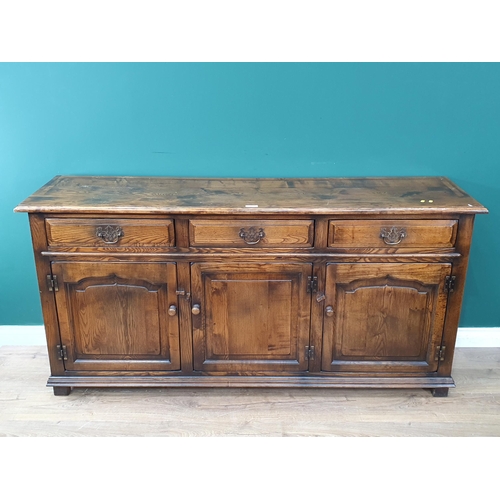 409 - A Titchmarsh & Goodwin style Oak Dresser Base with three fitted drawers above three panelled doors, ... 