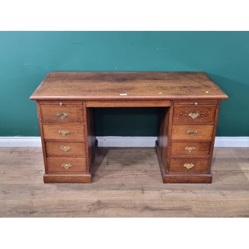 441 - An oak Pedestal Desk fitted eight drawers and two slides on plinth base, 2ft 5