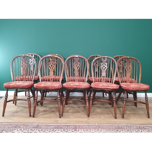 451 - A set of ten oak  Wheel back Dining Chairs by J.L.Browns  with pierced carved splats on turned suppo... 