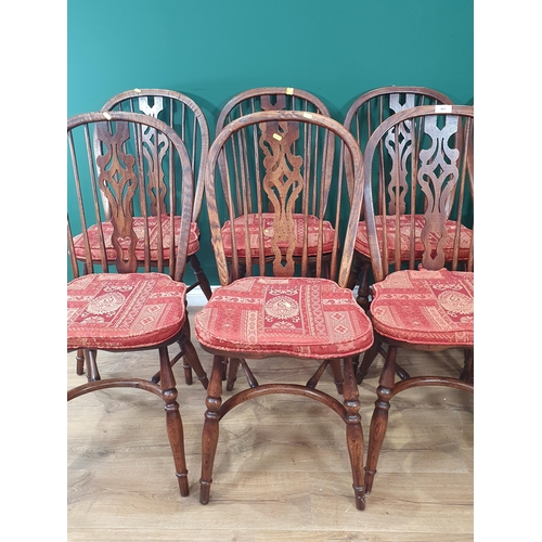 451 - A set of ten oak  Wheel back Dining Chairs by J.L.Browns  with pierced carved splats on turned suppo... 