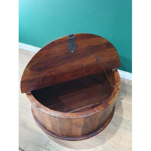 455 - An Indian hardwood circular Coffee Table with pair of hinged lids for storage and a pair of carry ha... 