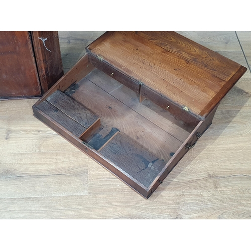 463 - An oak and elm Writing Slope the lift up lid with inset writing surface, fitted with four drawers an... 