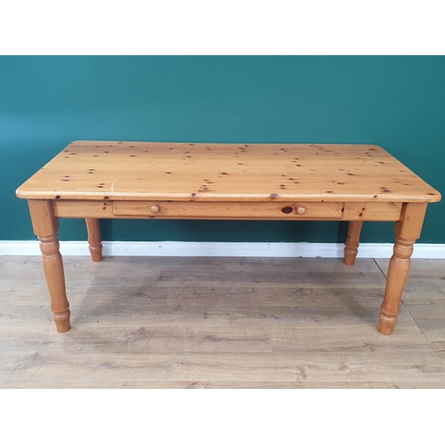 480 - A modern orange pine Kitchen Table with single fitted drawer raised on turned supports, 30